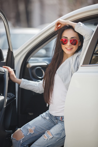 Very beautiful woman in the car holding flowers