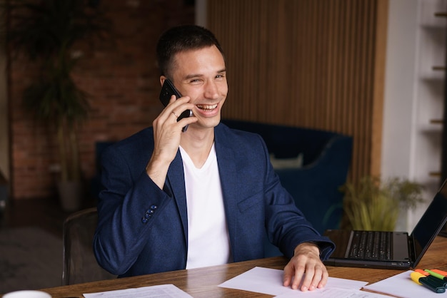 Very busy Confident successful man in jacket working on laptop and talking