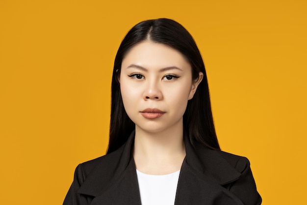 Very cute asian girl closeup portrait on a yellow background