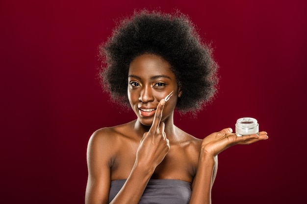 Very effective. Happy young woman smiling while enjoying her new facial cream