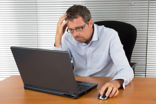 Very handsome man at work behind his laptop