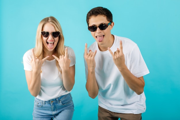 Very happy couple making the rock and roll gesture