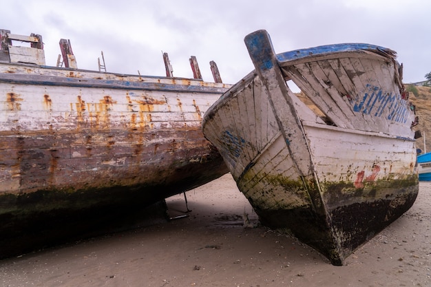 A very old boat on the sand