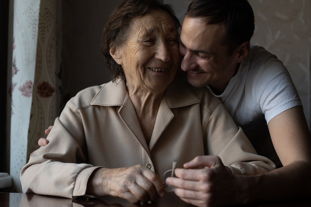 a very old woman and an adult grandson