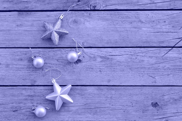 Very pery Christmas decorative balloons and stars on a rustic wooden background Waiting for the holiday a place for the text