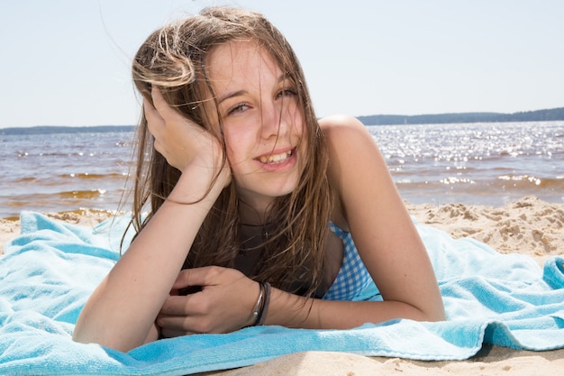 Very pretty young girl on the beach at summertime