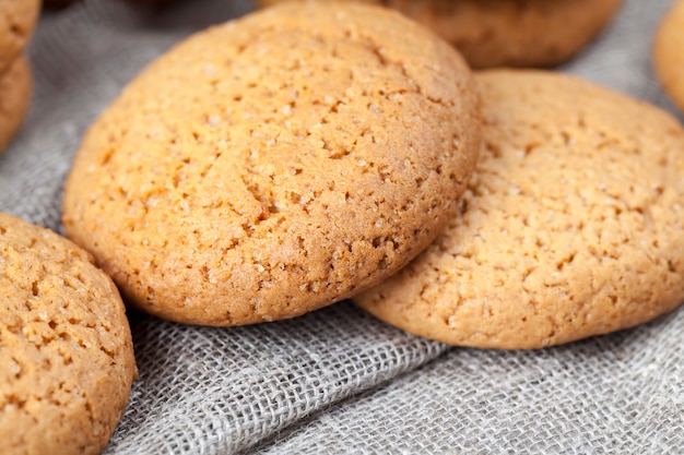 Not very sweet dry and crunchy cookies, porous cookies baked
with oatmeal, close-up of oatmeal cookies not very high in
calories