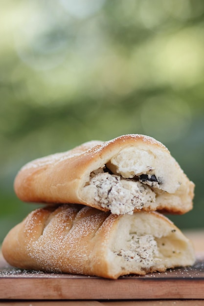 Very tasty and delicious pastries with cottage cheese and olives on a wooden table Tasty fresh crisp bakery product on a blurred background