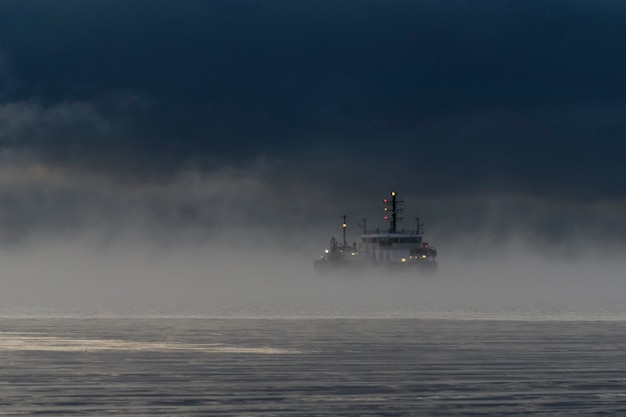 Vessel restricted in her ability to manoeuvre under way using engine at night time. Vessel engaged in dredging. Dredger working at sea. Collision regulations.