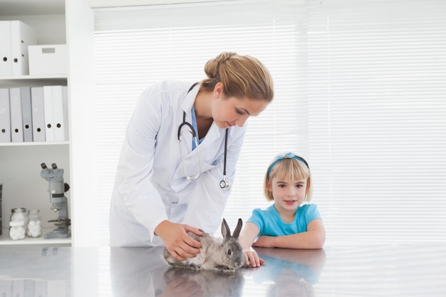 Vet showing a young girl a bunny rabbit