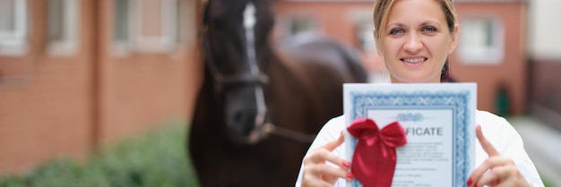 Veterinarian holds medical certificate for thoroughbred horse