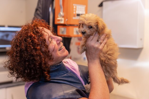 Veterinary clinic portrait of veterinary owner with a small dog