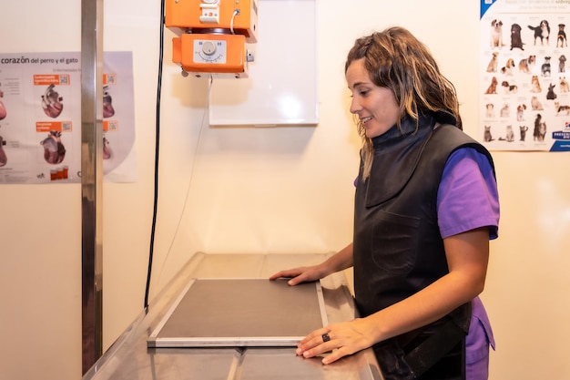 Veterinary clinic veterinarian preparing the material to make some xrays to a dog