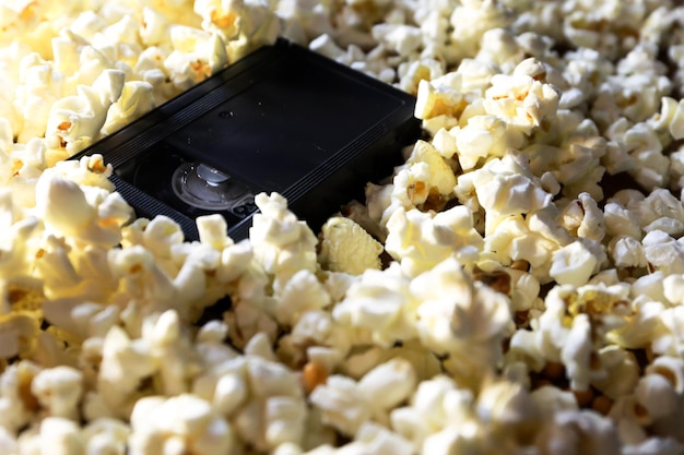 Photo vhs tape surrounded by popcorn.  love cinema
