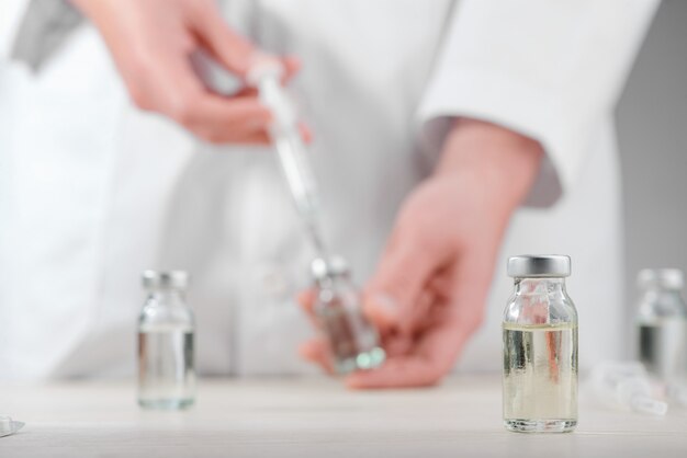 Vial on a desk in a laboratory in selective focus