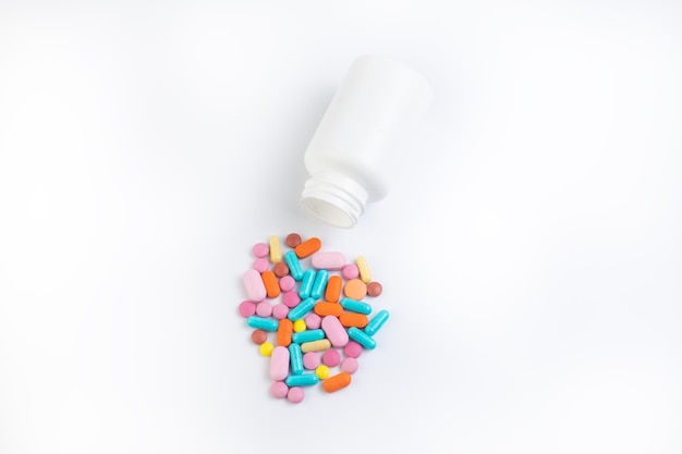 Vial with pills on white isolated background