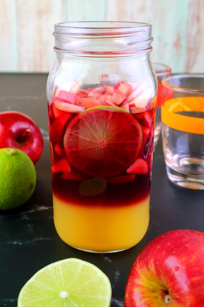 Vibrant color of homemade red wine sangria in a grass bottle before mixing