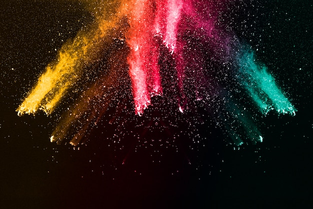 vibrant color powder explosion on black background.
