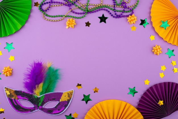 Vibrant mardi gras background with mask beads and festive decorations