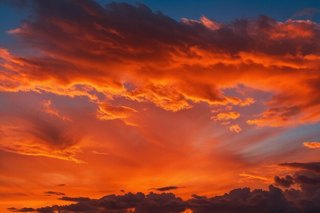 Vibrant orange hues illuminate the clouds in the sunset sky