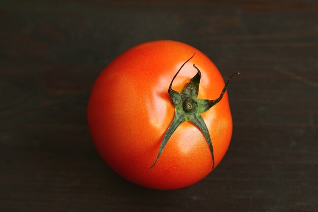 Vibrant red tomato isolated on black