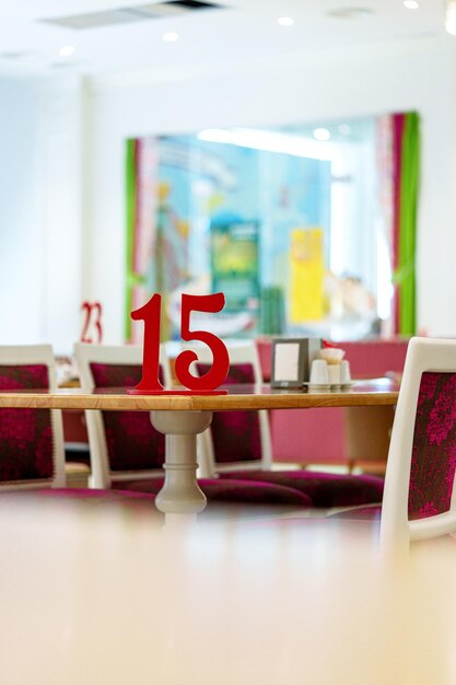 Vibrant restaurant interior with red number on table and colorful artwork in background