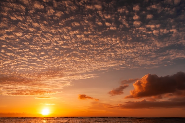 Vibrant sunset on ocean horizon with stunning cirrus and cumulonimbus clouds Iriomote Island