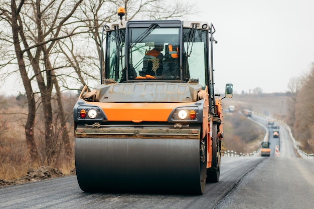 Vibratory asphalt roller compactor compacting new asphalt pavement Road service repairs the highway