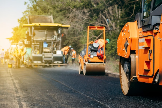 Vibratory asphalt rollers compactor compacting new asphalt pavement Road service build a new highwa