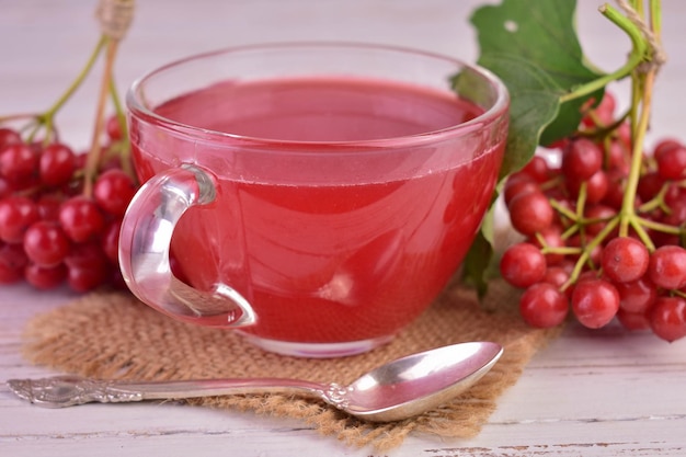 Viburnum tea in a transparent cup. Close-up.