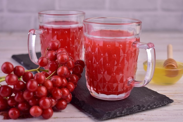 Viburnum tea with honey in transparent cups.