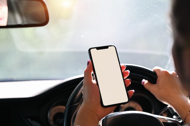 Vice over shoulder young man using smartphone while driving car