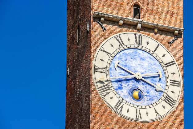 Vicenza, Italy. View of clock tower (Torre Bissara) at famous square (Piazza dei Signori) in Vicenza.