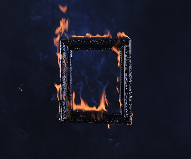 Victorian vintage frame on fire on black background