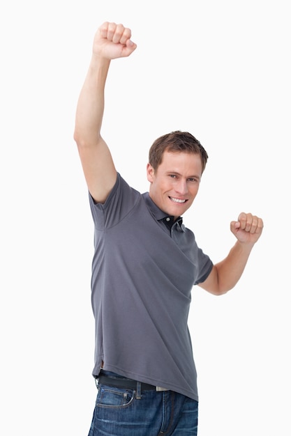 Victorious young man raising fist