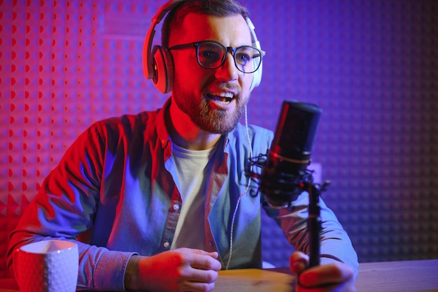 A video blogger records content in his studio the host of the\
video blog is a young man who is very enthusiastic about telling\
his subscribers a story