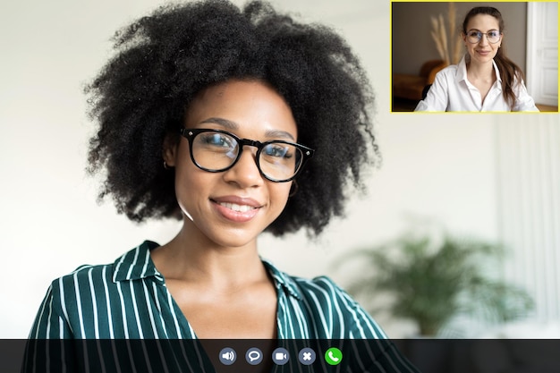 Photo video call a woman communicates with a colleague online laptop screen