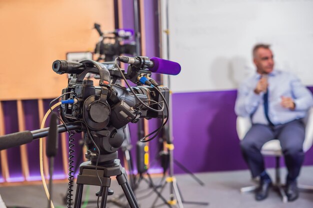 Video camera in conference room recording participants and speake