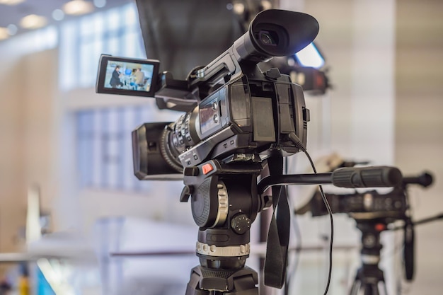 Video camera in conference room recording participants and speake