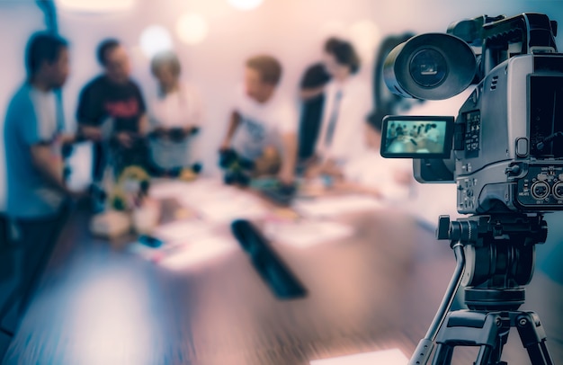 Video camera taking live video streaming at people working background