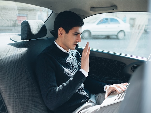 Video conference call. communication conversation. business work style. corporate man talking on the web on the backseat of his car.