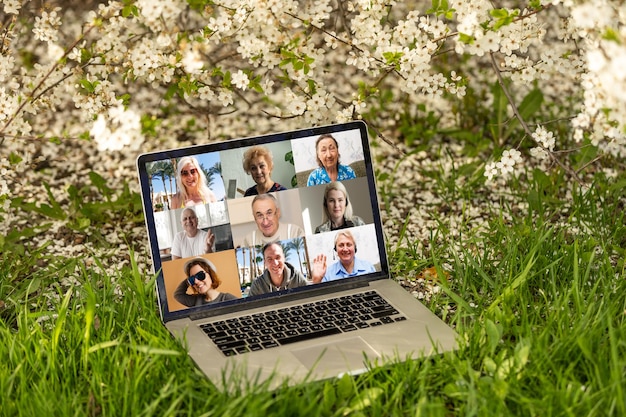 Video Conference Webinar Online Call Meeting On Laptop in a flower garden