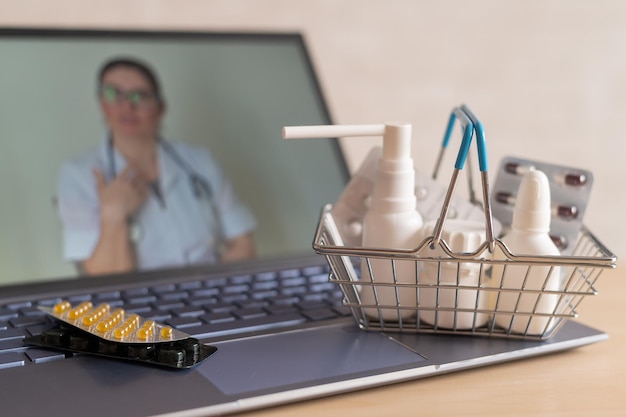 Video conference with a doctor on a laptop and tablet in a small shopping basket Online pharmacy Pharmacist on a computer screen