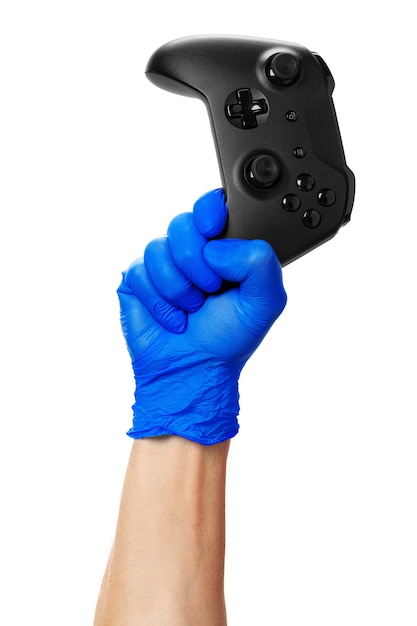 Video game console controller in gamer gloved hands. Games during isolation at home, coronavirus