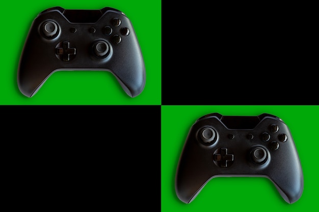 Video game controller and game controller. Black and green background. Selective focus. Space for text.