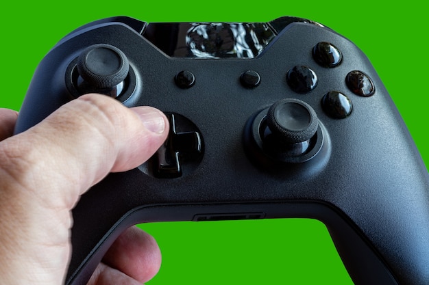 Video game controller and game controller. Green background. Selective focus. Space for text.