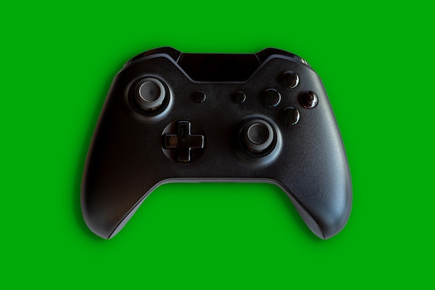 Video game controller and game controller. Green background. Selective focus.