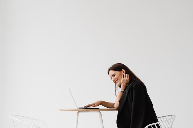 Video meeting with friends and colleagues and have fun online\
remotely after successful project girl with laptop smile laughs and\
discussing funny situations at work with colleagues