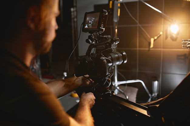 Video production backstage. behind the scenes of creating video content, a professional team of cameramen with a director filming commercial ads. video content creation, video creation industry.