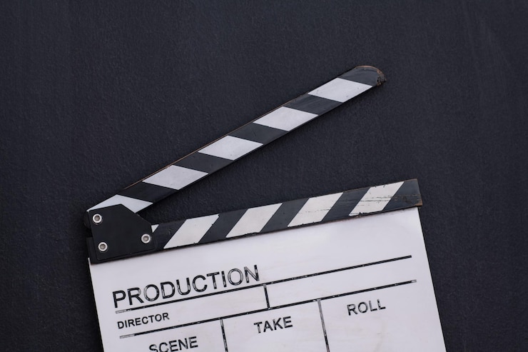 Photo video production movie clapper cinema action and cut concept on balck chalkboard background